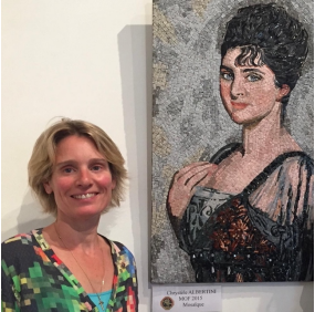 Image of Chrystèle Albertini in front of one of her mosaic works